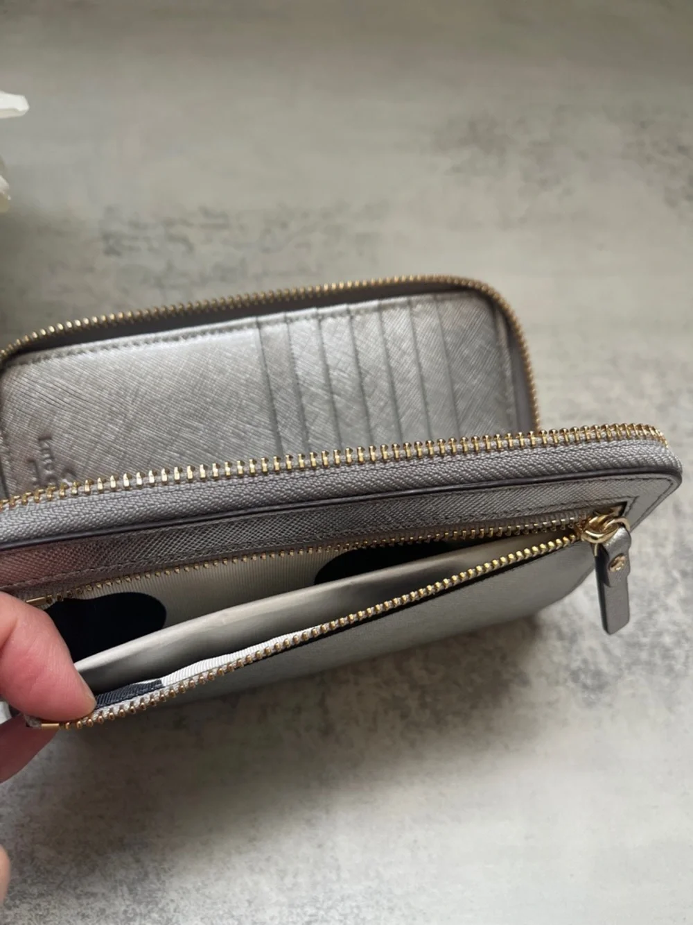 Kate Spade Laurie silver zip-around wristlet wallet